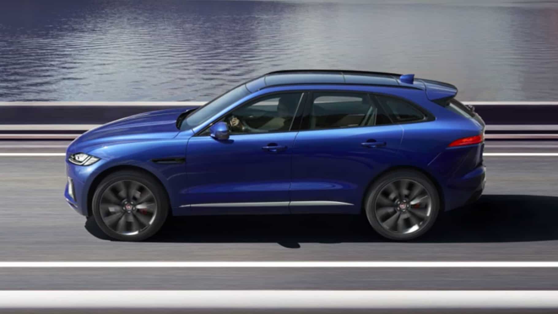 A jaguar F-Pace driving along a road by the sea.